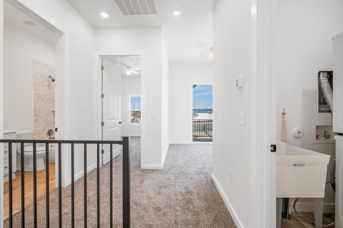 255 Lourdes Court, Unit A Dripping Springs, TX 78620 - Photo 19 of 27 a view of a bathroom with a sink and mirror