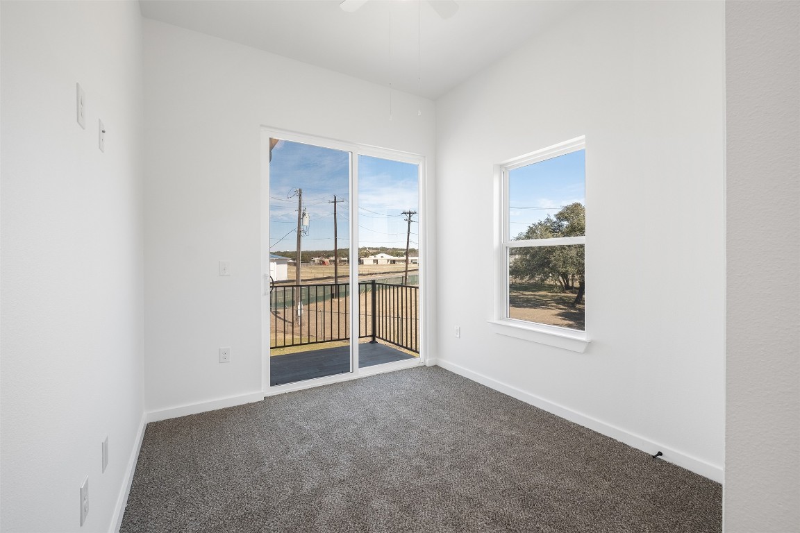 255 Lourdes Court, Unit A Dripping Springs, TX 78620 - Photo 21 of 27 a view of an empty room with a window