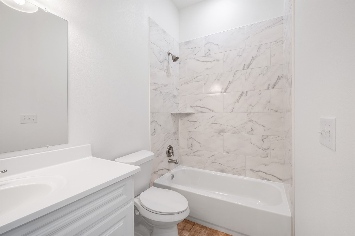 255 Lourdes Court, Unit A Dripping Springs, TX 78620 - Photo 25 of 27 a bathroom with a bathtub and toilet