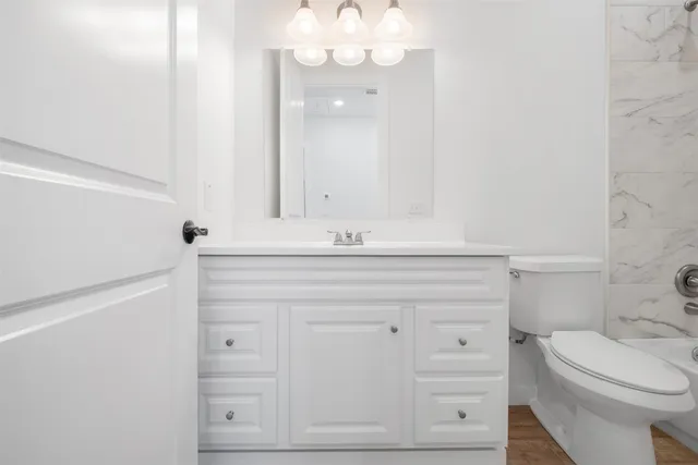 a big white house with a yard and large trees