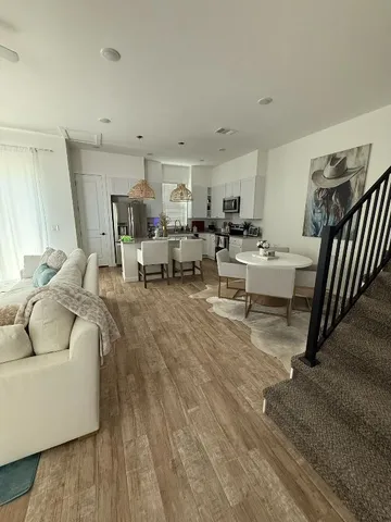 a living room with furniture and a chandelier