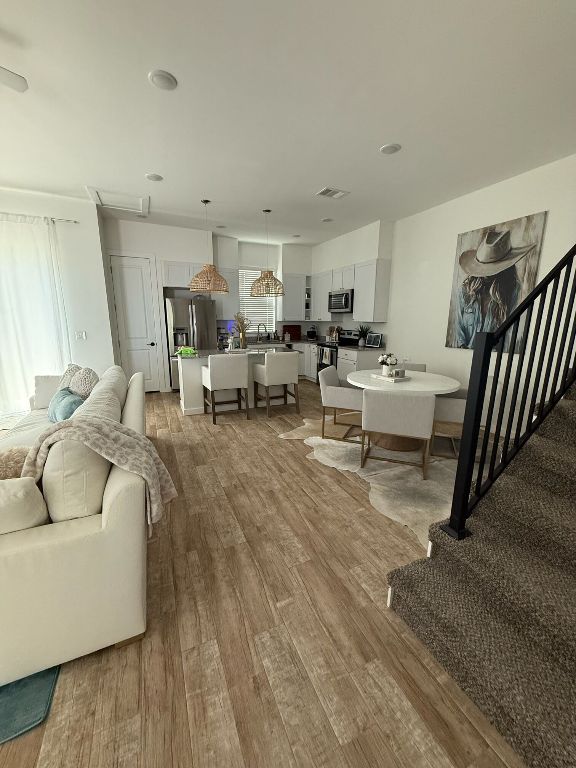 255 Lourdes Court, Unit A Dripping Springs, TX 78620 - Photo 3 of 27 a living room with furniture and a wooden floor