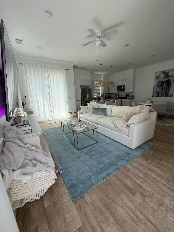 255 Lourdes Court, Unit A Dripping Springs, TX 78620 - Photo 4 of 27 a living room with furniture and a chandelier