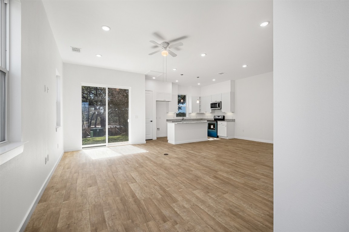 255 Lourdes Court, Unit A Dripping Springs, TX 78620 - Photo 5 of 27 a view of kitchen with wooden floor and window
