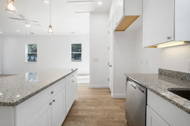 a view of a kitchen with sink and natural light