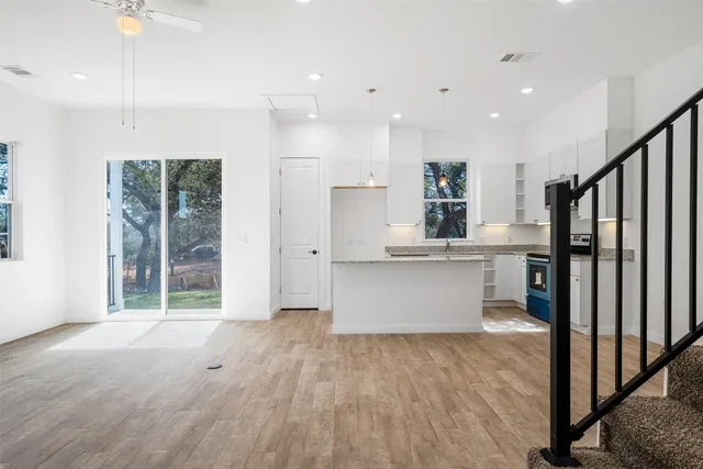 a bathroom with a granite countertop toilet and a sink