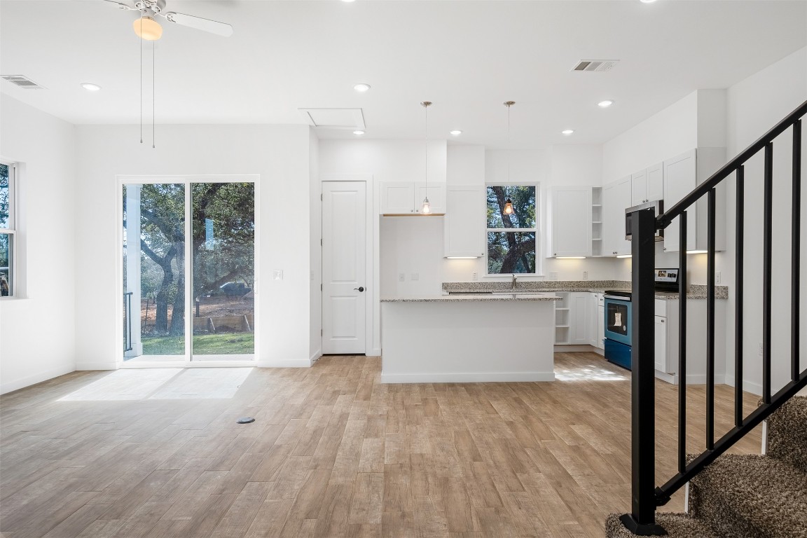 255 Lourdes Court, Unit A Dripping Springs, TX 78620 - Photo 9 of 27 a view of kitchen with wooden floor and electronic appliances