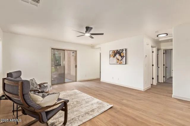 a living room with furniture and wooden floor