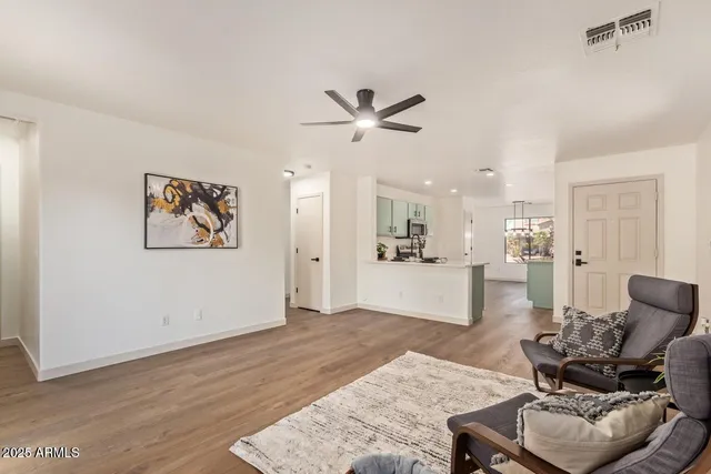 a living room with furniture and kitchen view