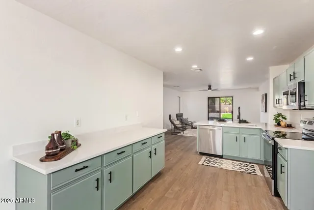 a kitchen with a sink stove and cabinets