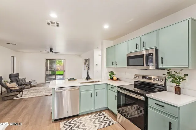 a kitchen with a sink stove and microwave
