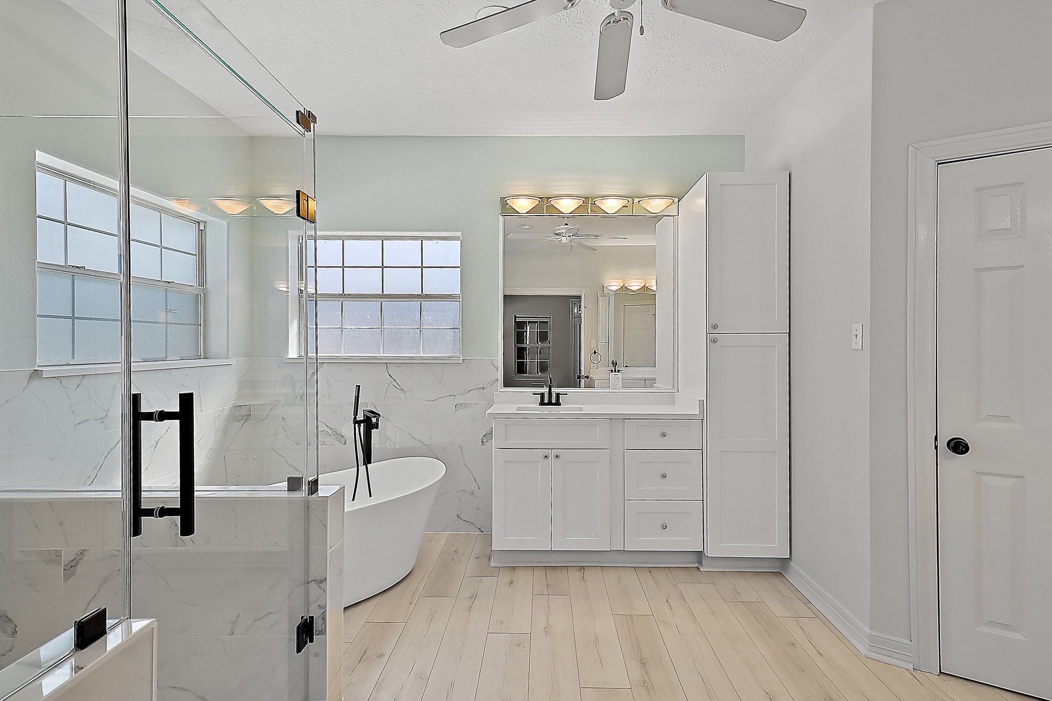 1306 Spring Branch Drive Baytown, TX 77523 - Photo 25 of 38 a bathroom with a double vanity sink a mirror and a bathtub