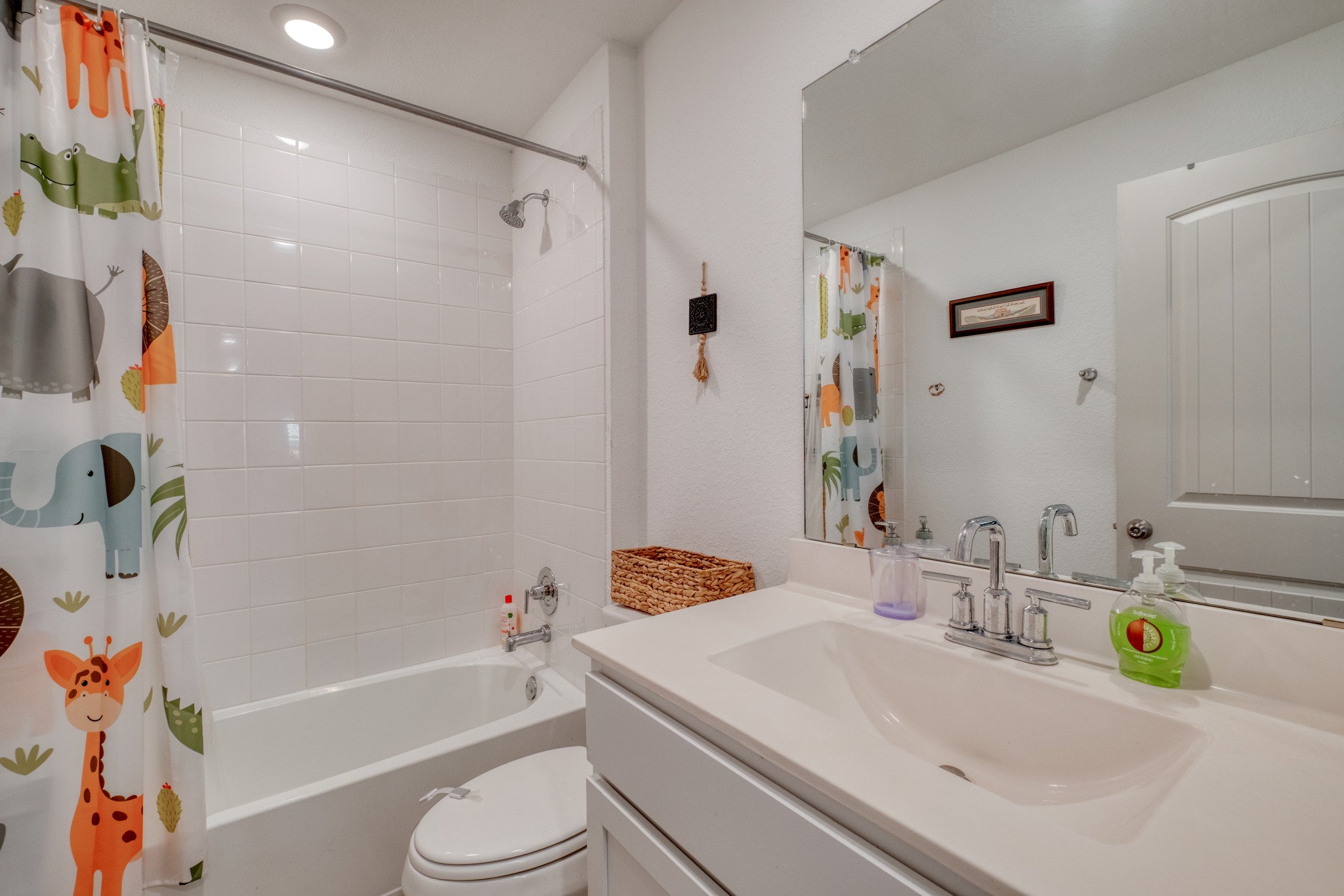 102 Johnson Draw Road Hutto, TX 78634 - Photo 23 of 30 Tiled shower surround and a clean white vanity highlight this well-appointed bathroom.