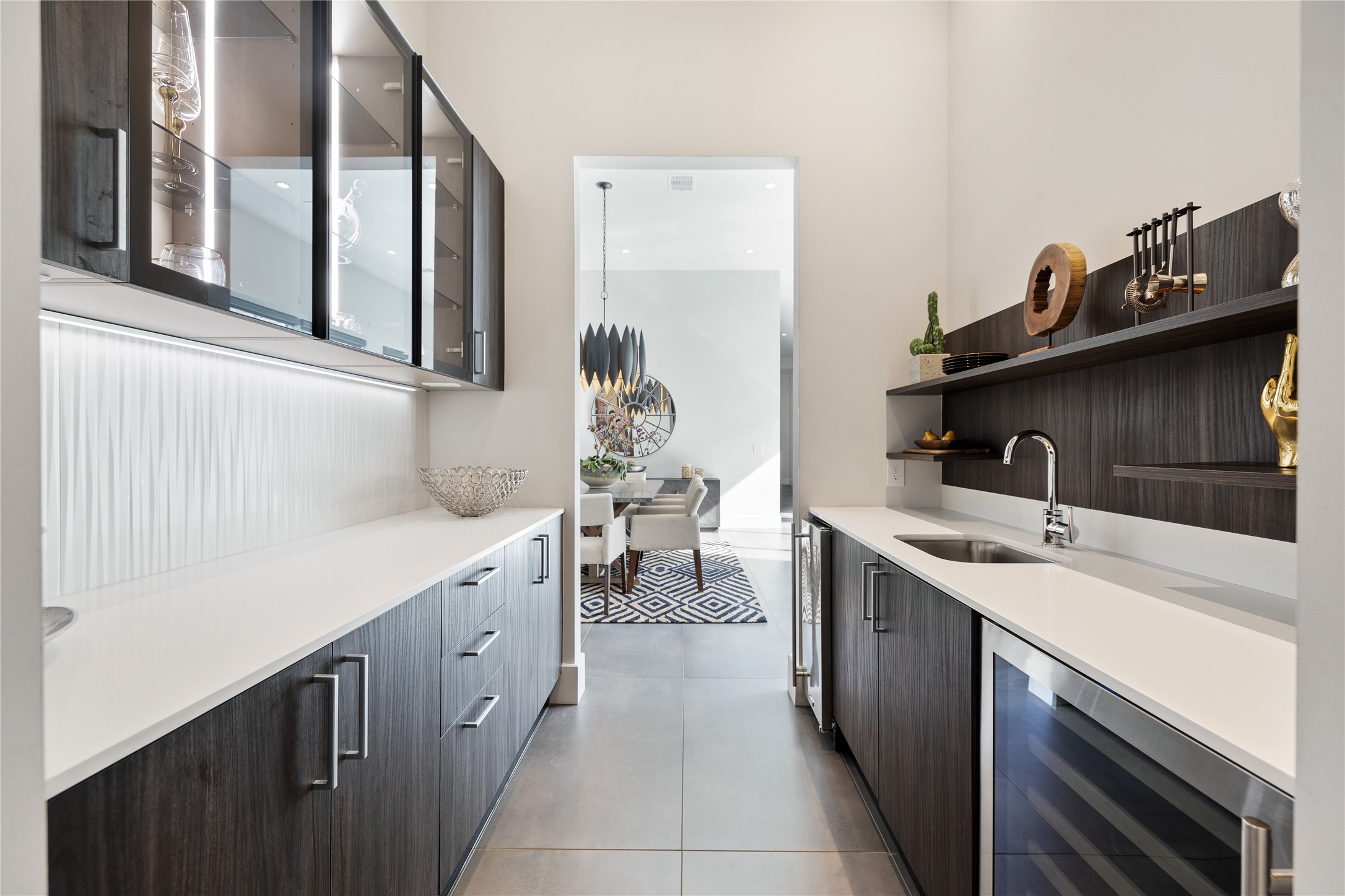 103 Roy Street Houston, TX 77007 - Photo 15 of 37 Well-appointed butler’s pantry featuring custom cabinetry, built-in beverage storage, and additional prep space that enhances functionality while maintaining the home’s cohesive modern design aesthetic.
