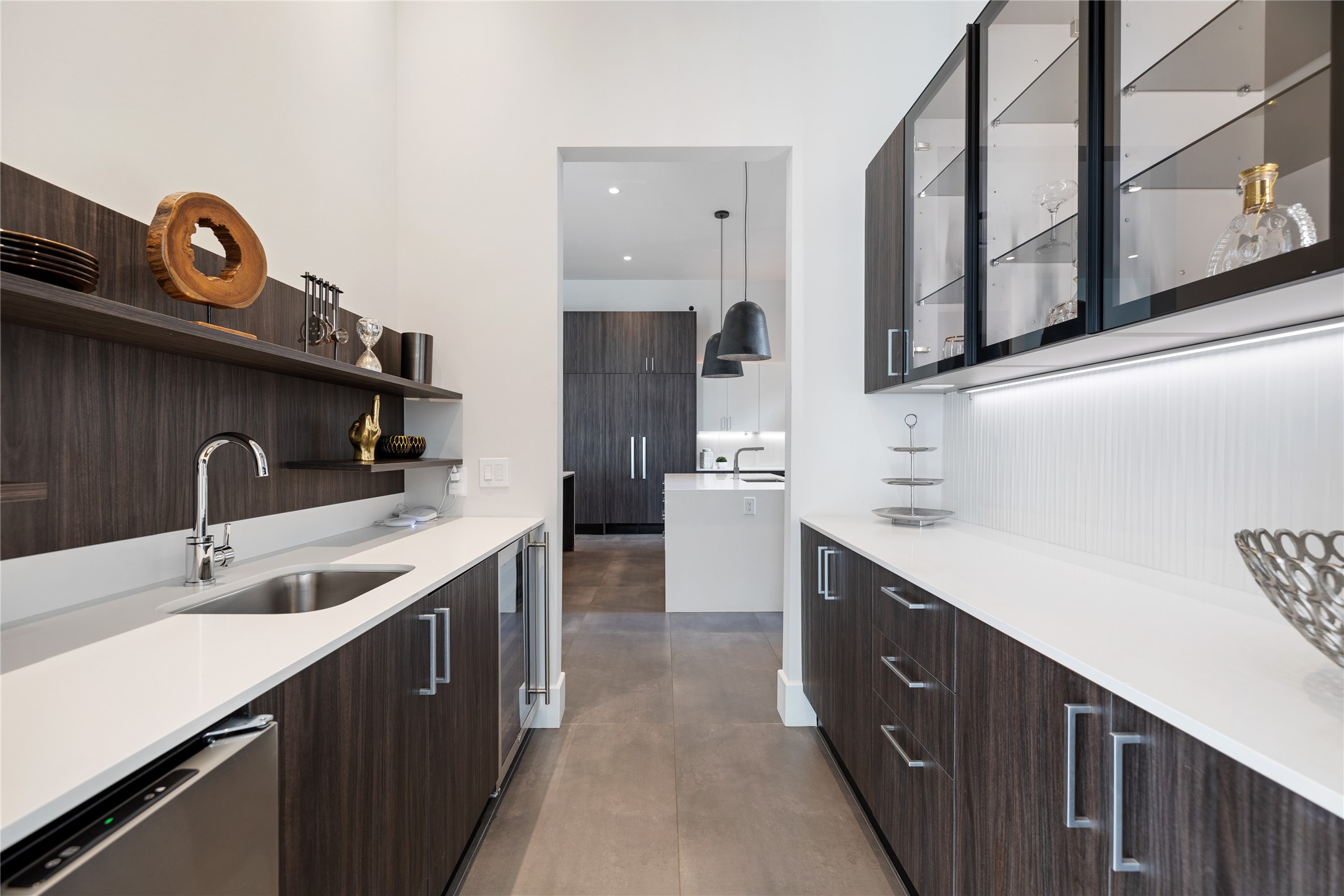 103 Roy Street Houston, TX 77007 - Photo 16 of 37 Extended butler’s pantry offers additional preparation space, built-in storage, and beverage refrigeration, providing functional convenience while maintaining the home’s streamlined contemporary aesthetic.