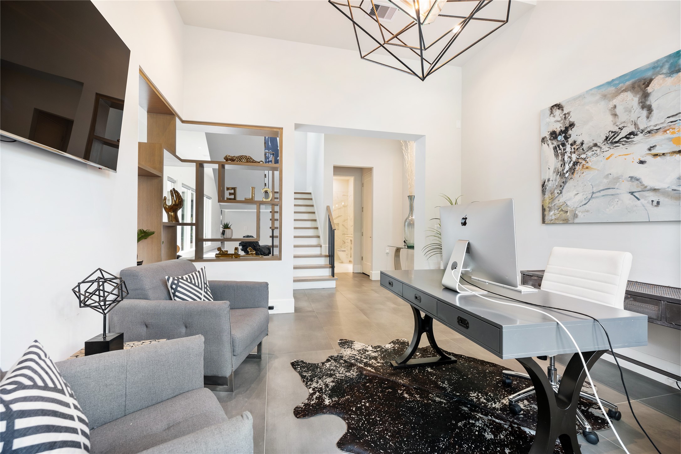 103 Roy Street Houston, TX 77007 - Photo 18 of 37 Dedicated office space positioned near the entry offers flexibility for work or study, enhanced by elevated ceilings, modern lighting, and open sightlines that contribute to the home’s cohesive architectural flow.