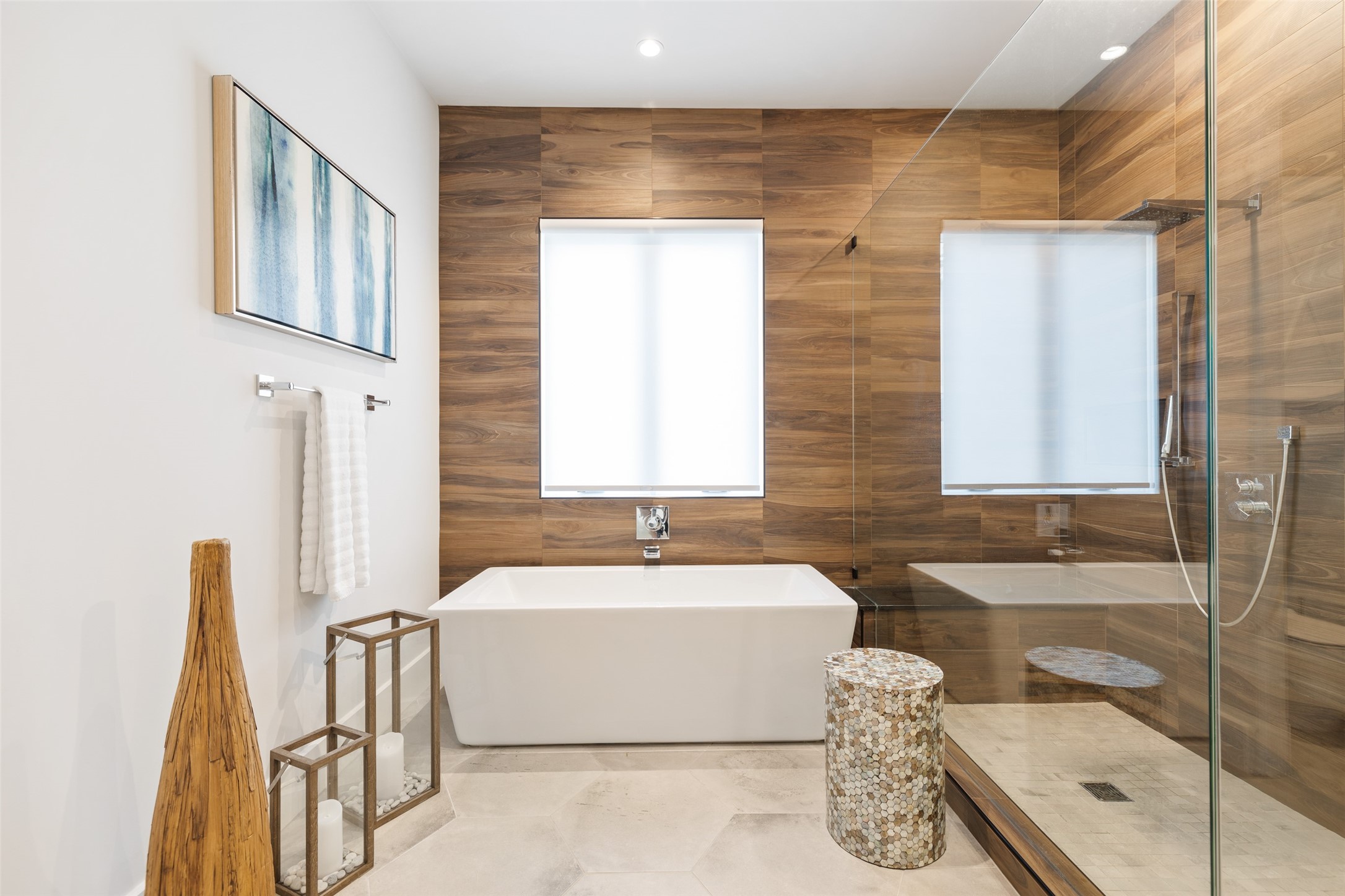 103 Roy Street Houston, TX 77007 - Photo 22 of 37 Spa-inspired primary bath featuring a freestanding soaking tub, expansive glass-enclosed shower, and warm wood accent wall that creates a calming and refined retreat atmosphere.