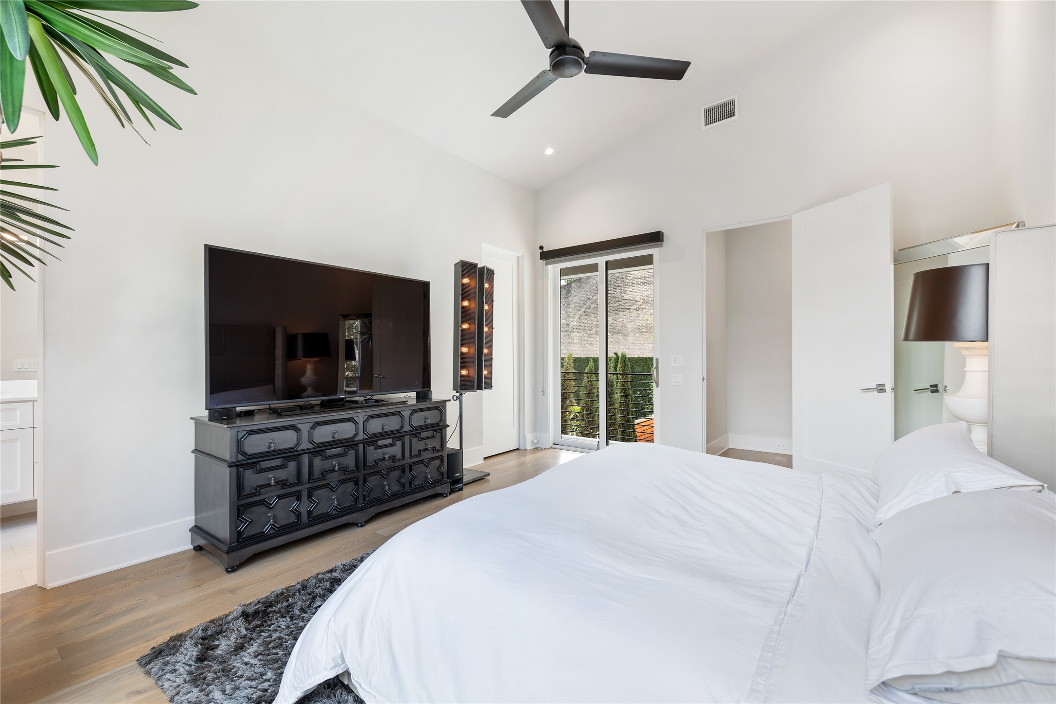 103 Roy Street Houston, TX 77007 - Photo 27 of 37 a bedroom with a bed and a flat screen tv