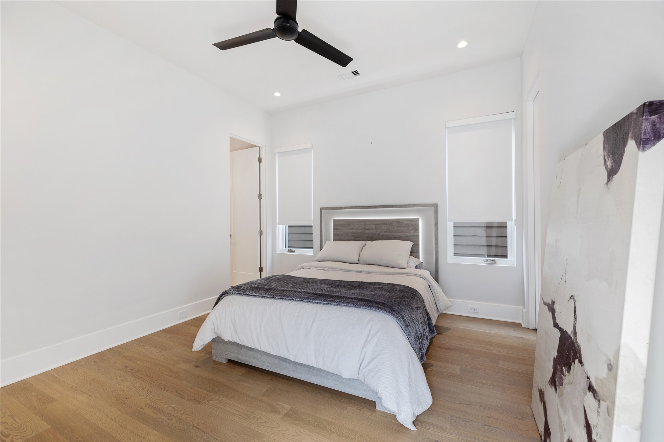 103 Roy Street Houston, TX 77007 - Photo 30 of 37 a bedroom with a bed and a ceiling fan