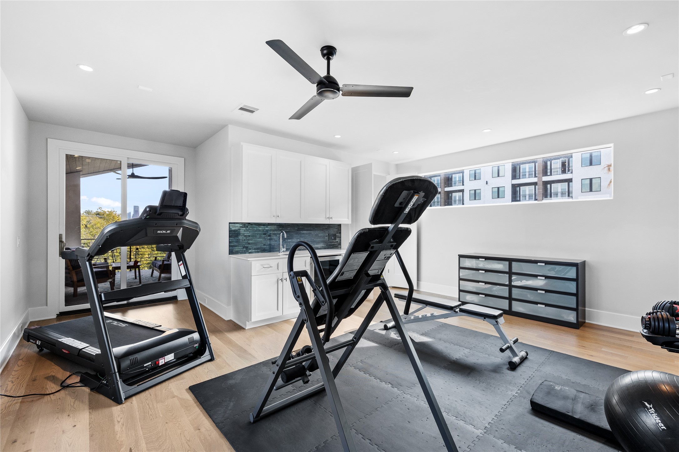 103 Roy Street Houston, TX 77007 - Photo 32 of 37 a living room with gym equipment and windows