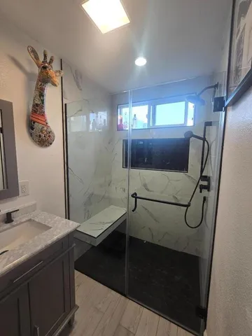 a bathroom with a shower and mirror