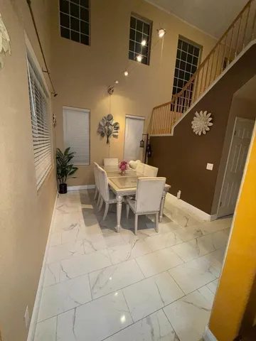 a dining room with furniture and wooden floor