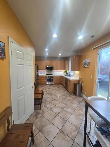 a kitchen with a table and chairs