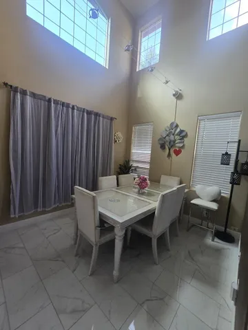 a dining room with furniture and wooden floor