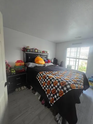 a bedroom with bed and window