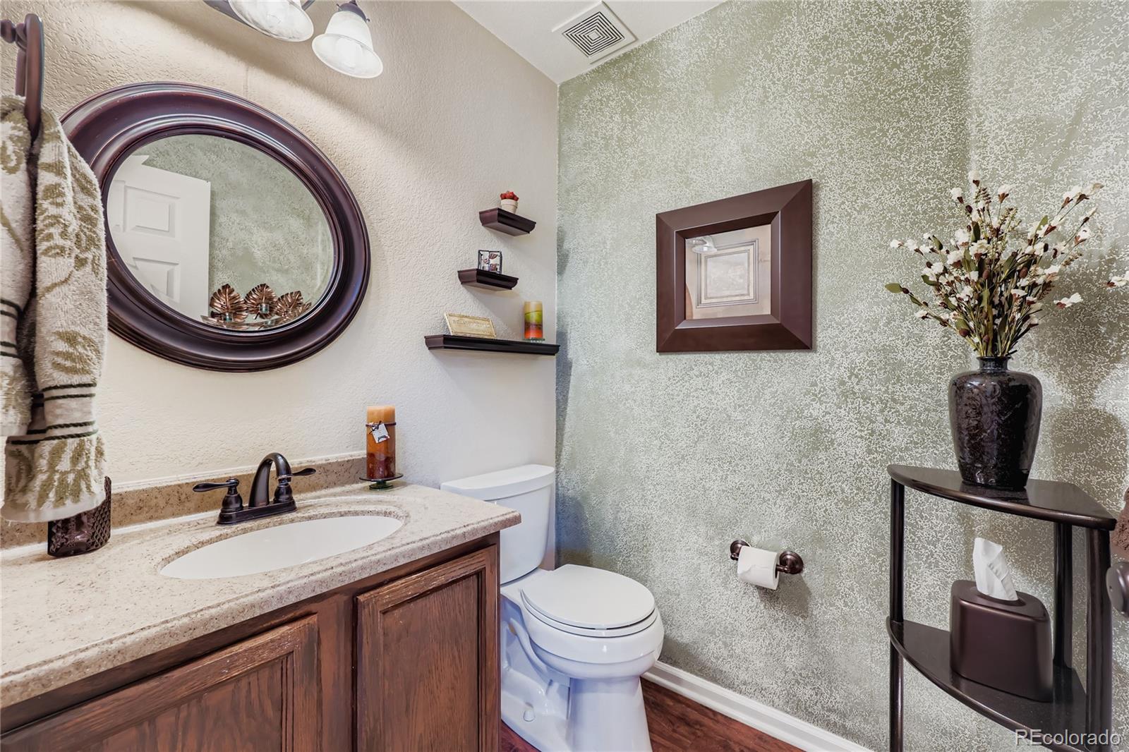 1005 Parsons Avenue Castle Rock, CO 80104 - Photo 13 of 38 a bathroom with a toilet a sink and mirror