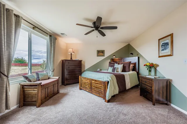 a bedroom with bed and window