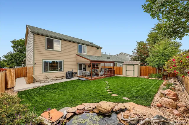 a view of a house with couches chairs and a yard