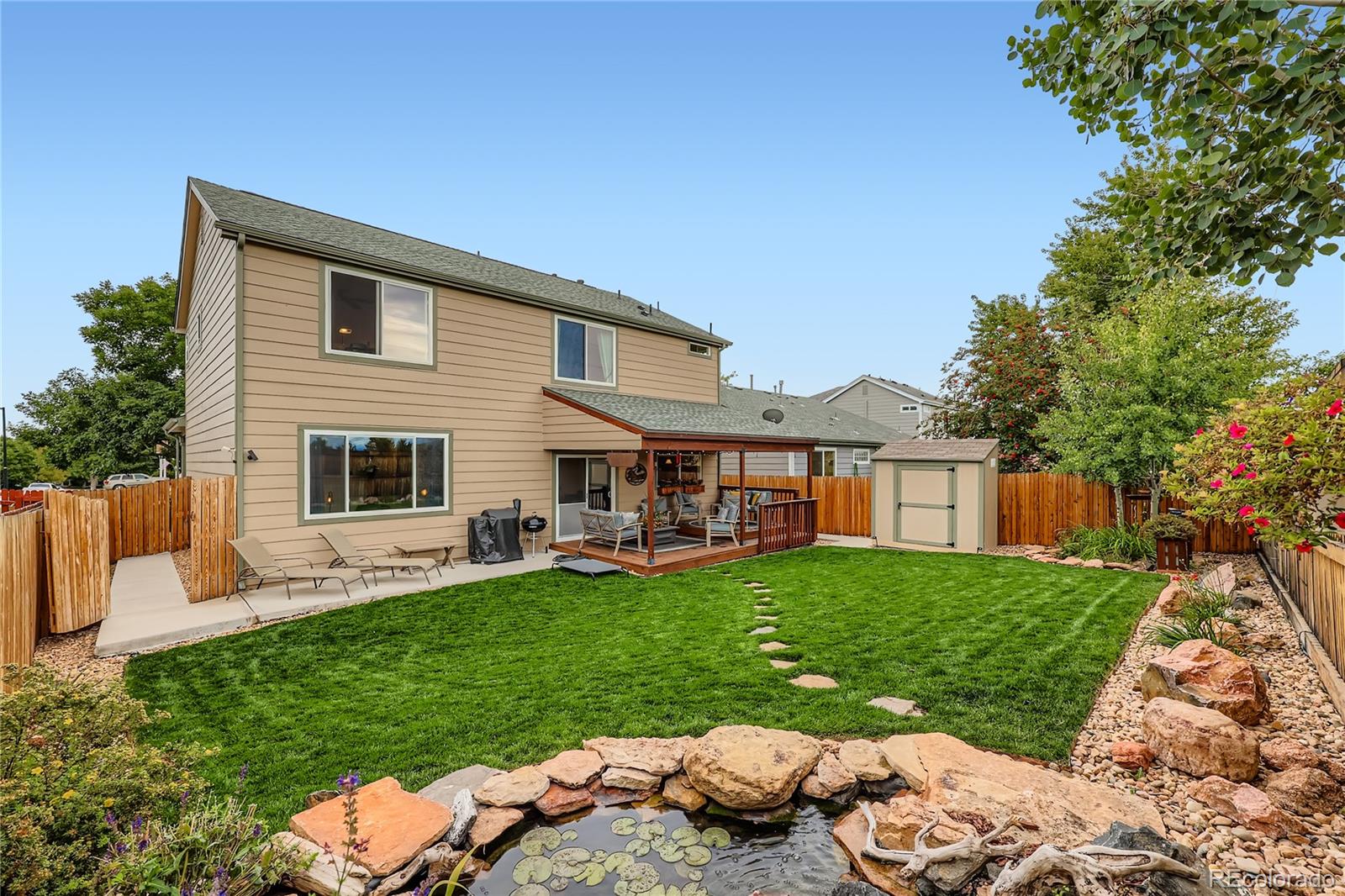 1005 Parsons Avenue Castle Rock, CO 80104 - Photo 24 of 38 a view of a house with couches chairs and a yard