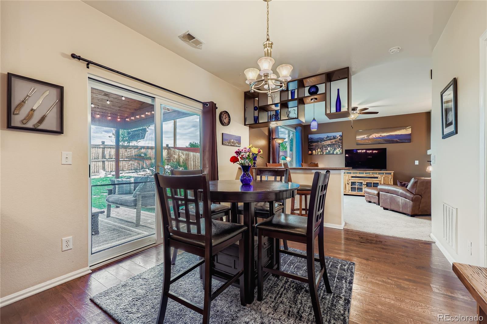 1005 Parsons Avenue Castle Rock, CO 80104 - Photo 9 of 38 a view of a dining room with furniture a chandelier and wooden floor