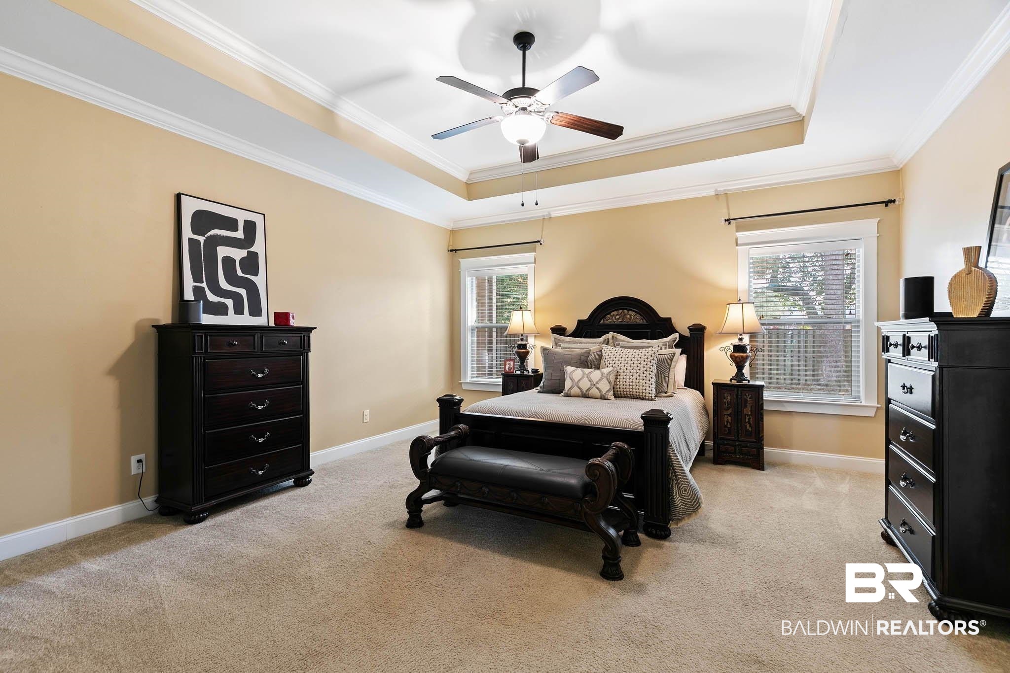 19740 Bunker Loop Fairhope, AL 36532 - Photo 18 of 33 Bedroom featuring a raised ceiling, light carpet, crown molding, and a ceiling fan