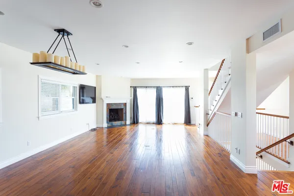 a view of a house with wooden floor and stairs