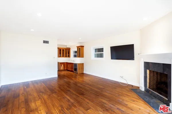 a view of a livingroom with an empty space and a fireplace