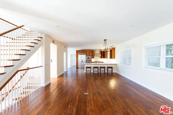a dining room with furniture and wooden floor
