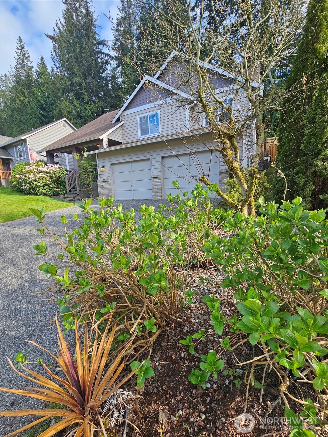6108 133rd Place Southwest Edmonds, WA 98026 - Photo 37 of 40 a front view of a house with a yard and potted plants