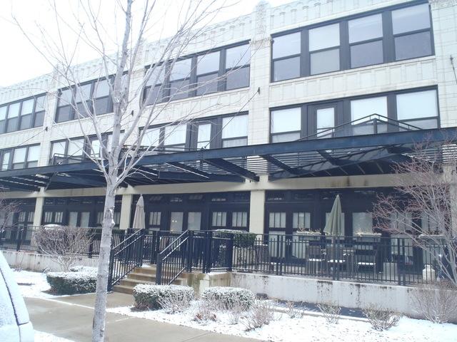 1151 West 15th Street, Unit 131 Chicago, IL 60608 - Photo 1 of 1 a front view of a building and a yard