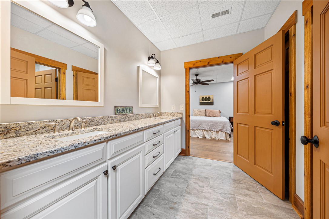 285 Bertha Allen Road Westminster, SC 29693 - Photo 24 of 50 Double vanity with stone counters provides ample space and functionality in this bathroom.