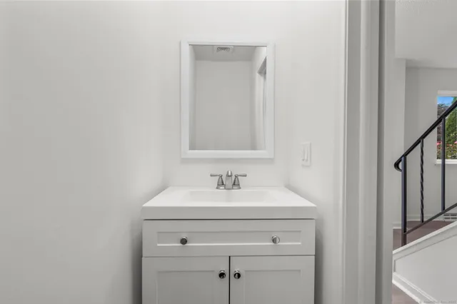 an empty room with a window and ceiling fan