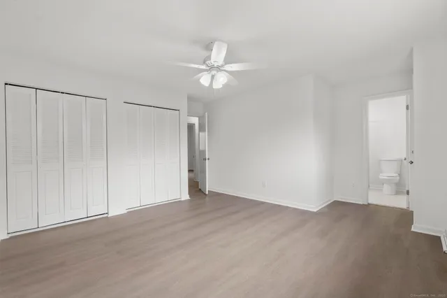 a bathroom with a shower a sink a toilet and a mirror