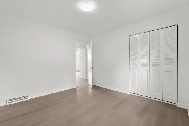 a bathroom with a toilet sink vanity tub and shower