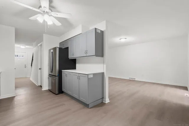 a view of a kitchen with a sink and a refrigerator