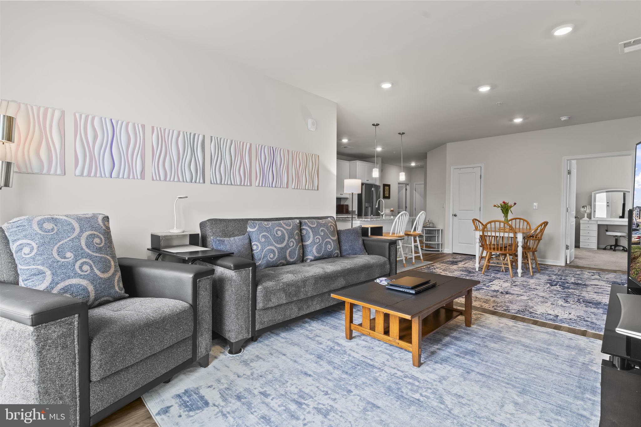 4007 Seaside Alder Road, Unit 8307 Bowie, MD 20720 - Photo 11 of 32 a living room with furniture and a wooden floor