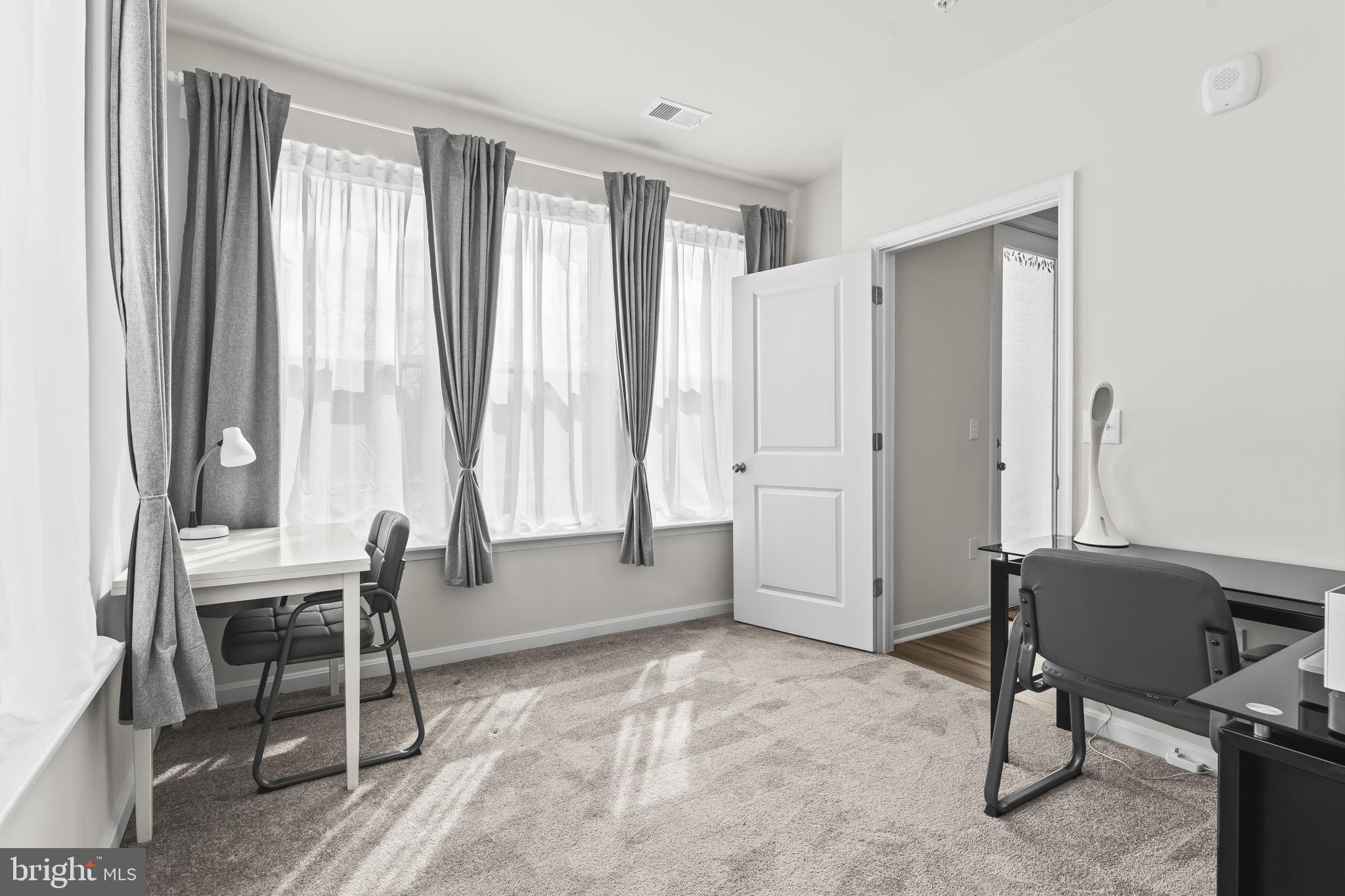 4007 Seaside Alder Road, Unit 8307 Bowie, MD 20720 - Photo 13 of 32 a view of a livingroom with furniture and a window