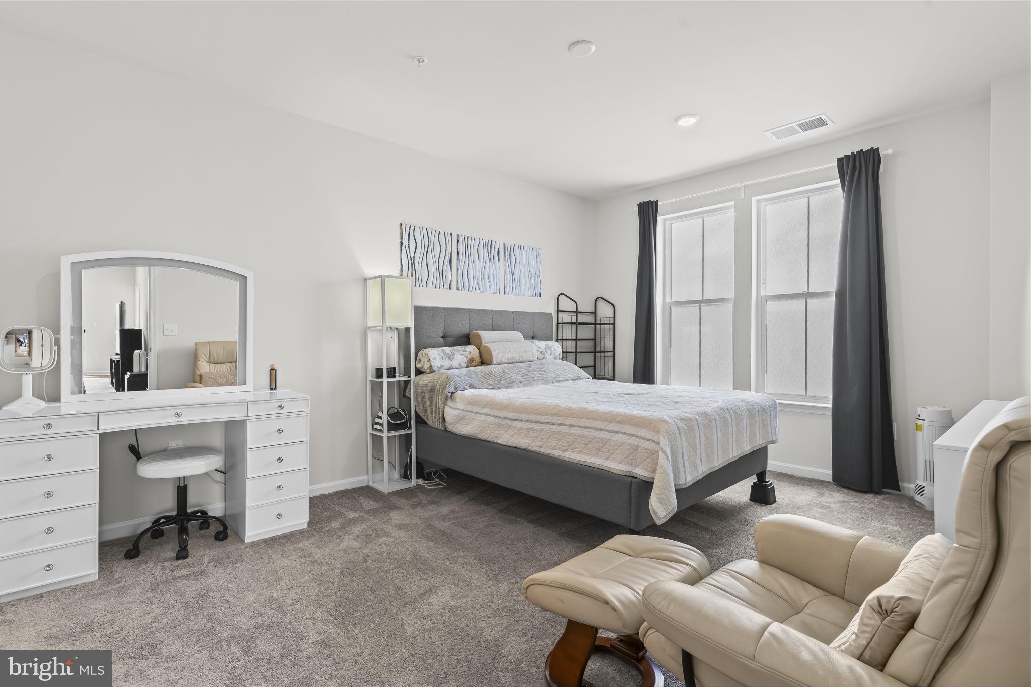 4007 Seaside Alder Road, Unit 8307 Bowie, MD 20720 - Photo 17 of 32 a bed room with a bed window and a chair