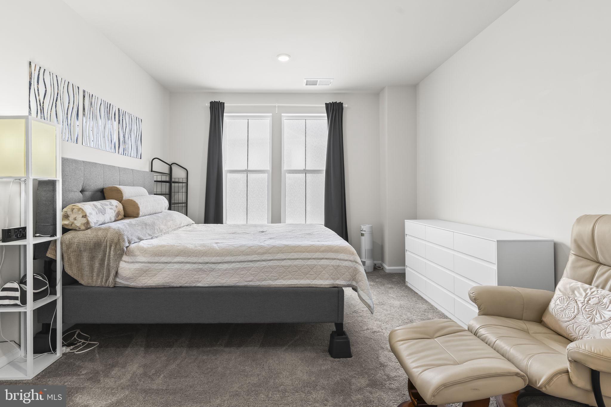 4007 Seaside Alder Road, Unit 8307 Bowie, MD 20720 - Photo 18 of 32 a bedroom with a bed and a couch