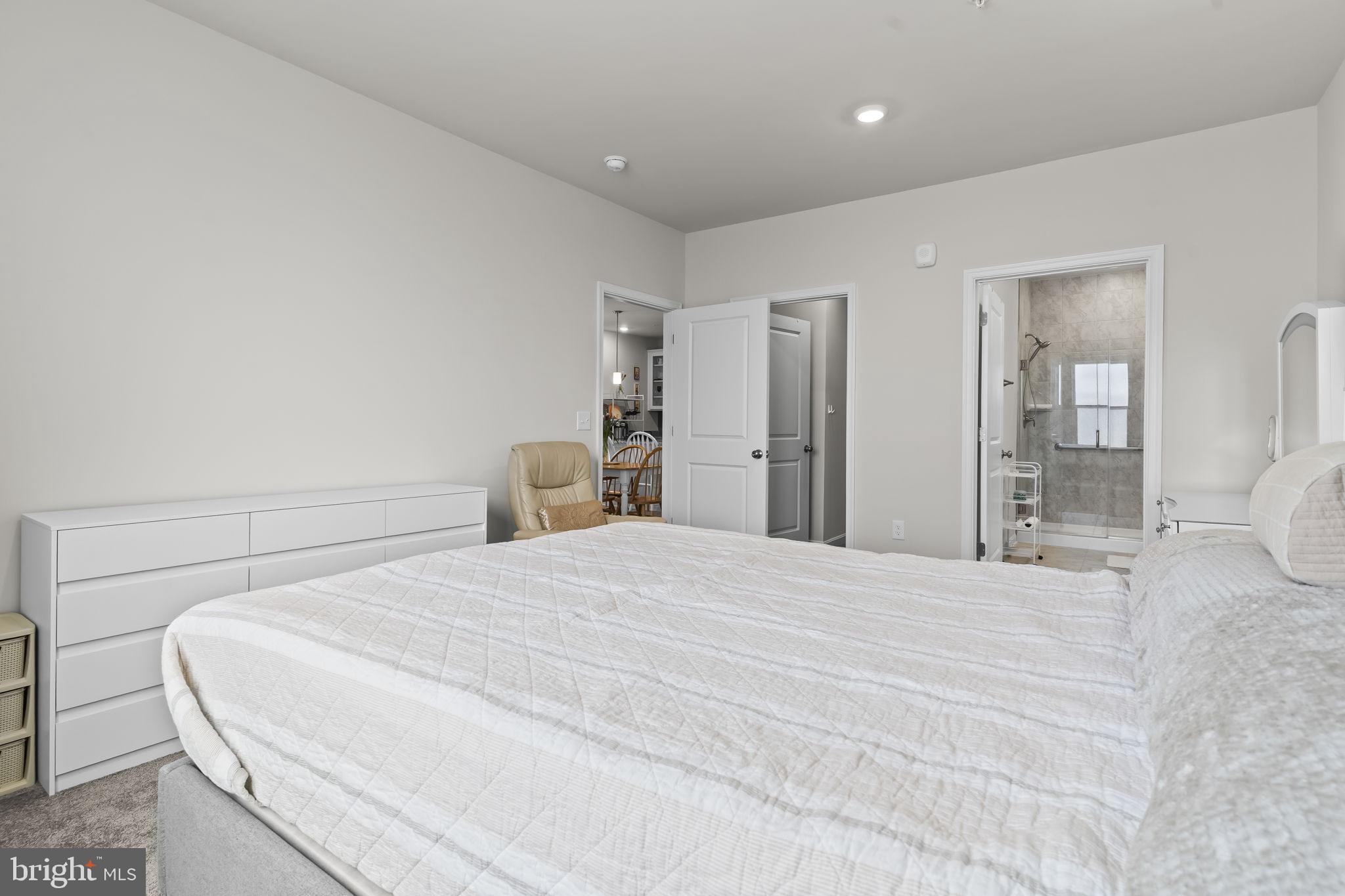 4007 Seaside Alder Road, Unit 8307 Bowie, MD 20720 - Photo 20 of 32 a large white bed in a white room